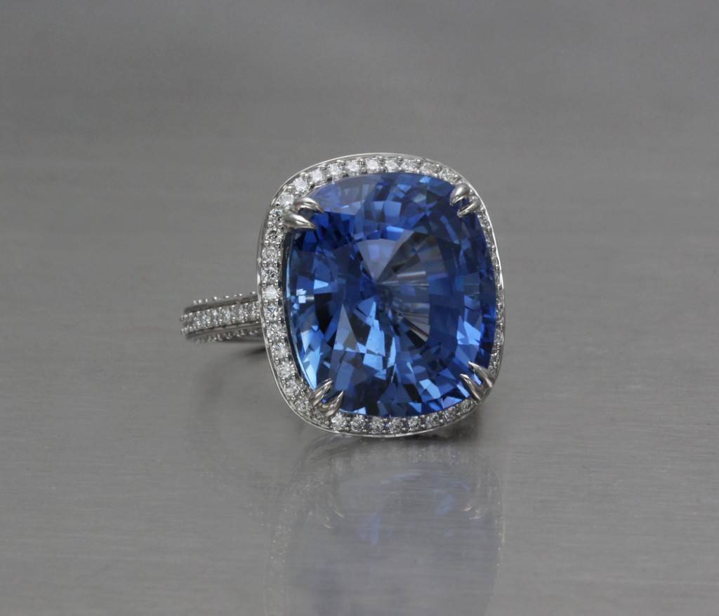 Blue sapphire ring surrounded by a halo of small diamonds